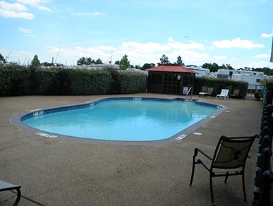 A large swimming pool with a chair in front of it