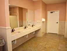 A bathroom with a lot of sinks and mirrors.