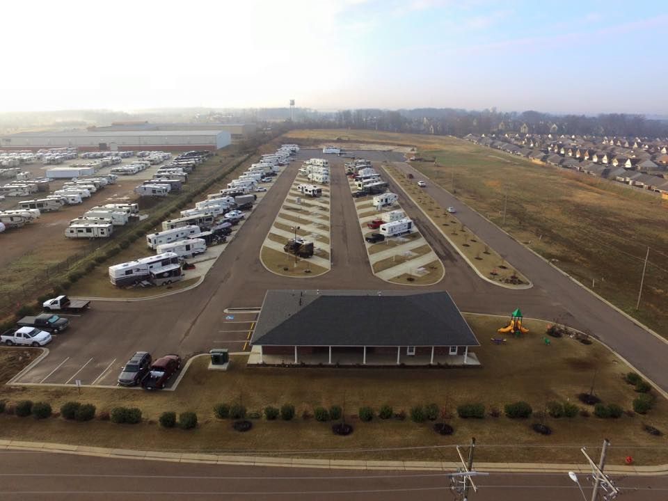An aerial view of a parking lot filled with rvs.