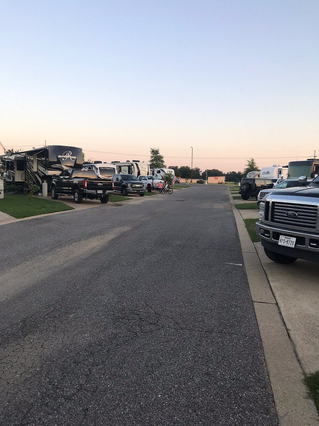 A row of rvs parked on the side of a road.