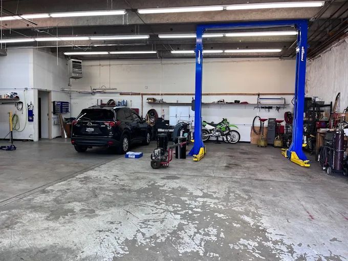A car is on a lift in a garage.| Ridgeline Automotive