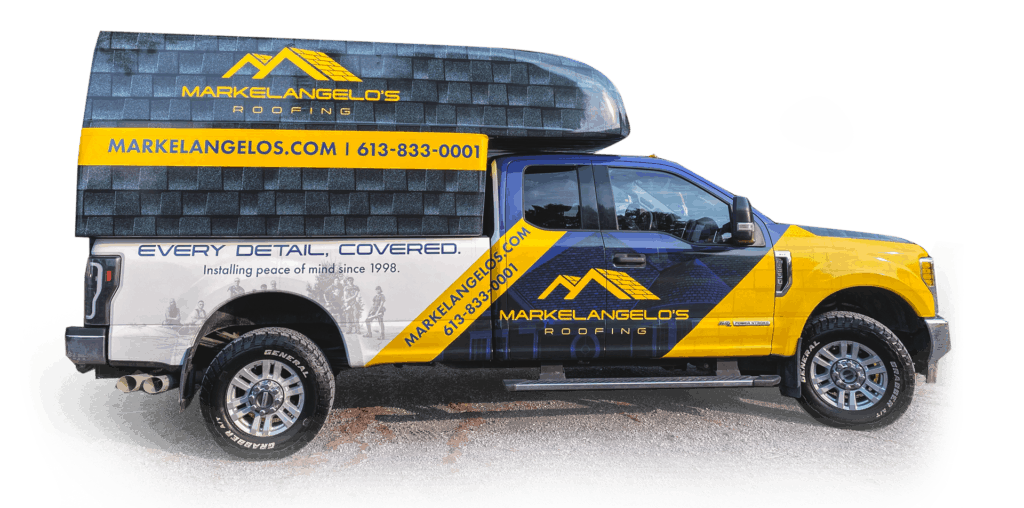 Yellow and blue roofing truck with roofing material on top. WAKELANDELOS.COM is written on the side.