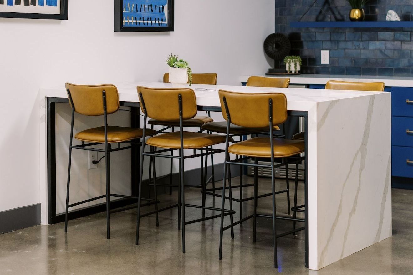 A lobby space with a table and chairs in it.