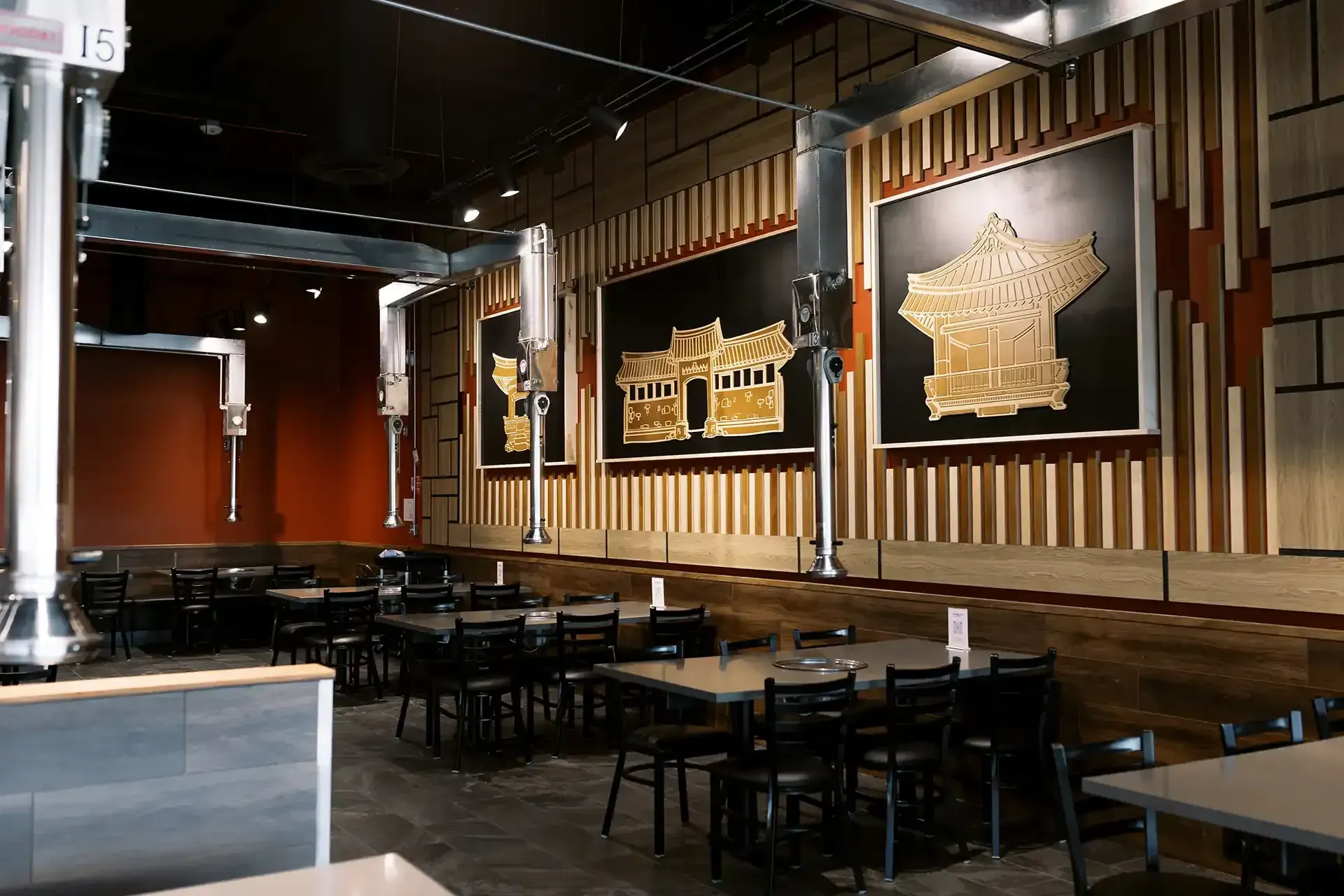 A restaurant with tables and chairs and a painting on the wall.