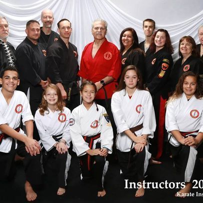 A group of karate instructors pose for a photo
