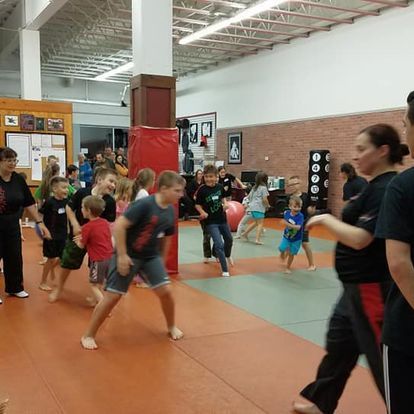 A group of people are playing in a gym.