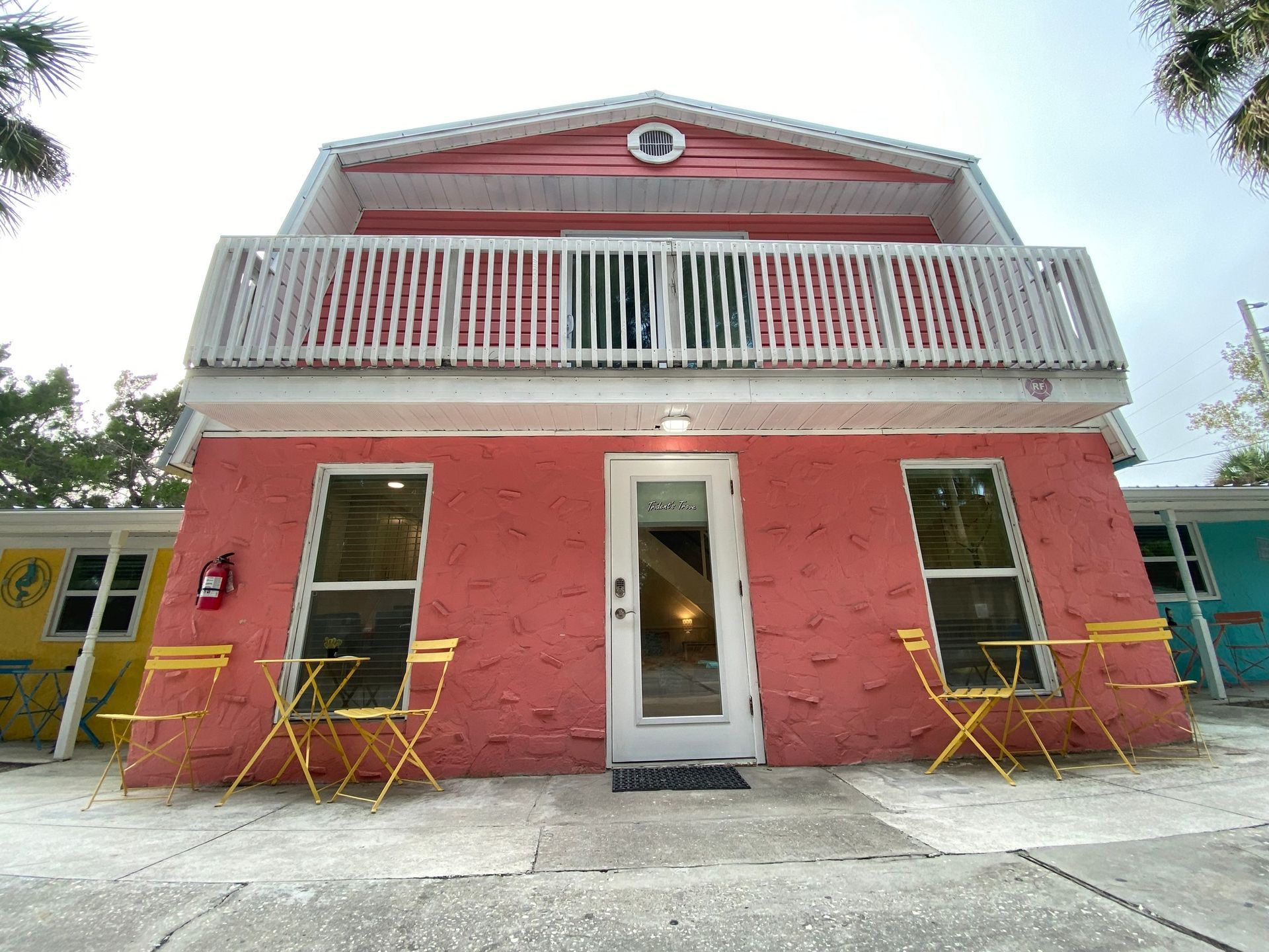 A picnic table and chairs on a sandy beach next to a river.