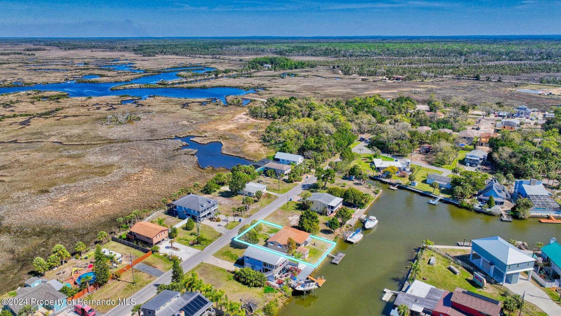 An aerial view of a residential area next to a body of water.