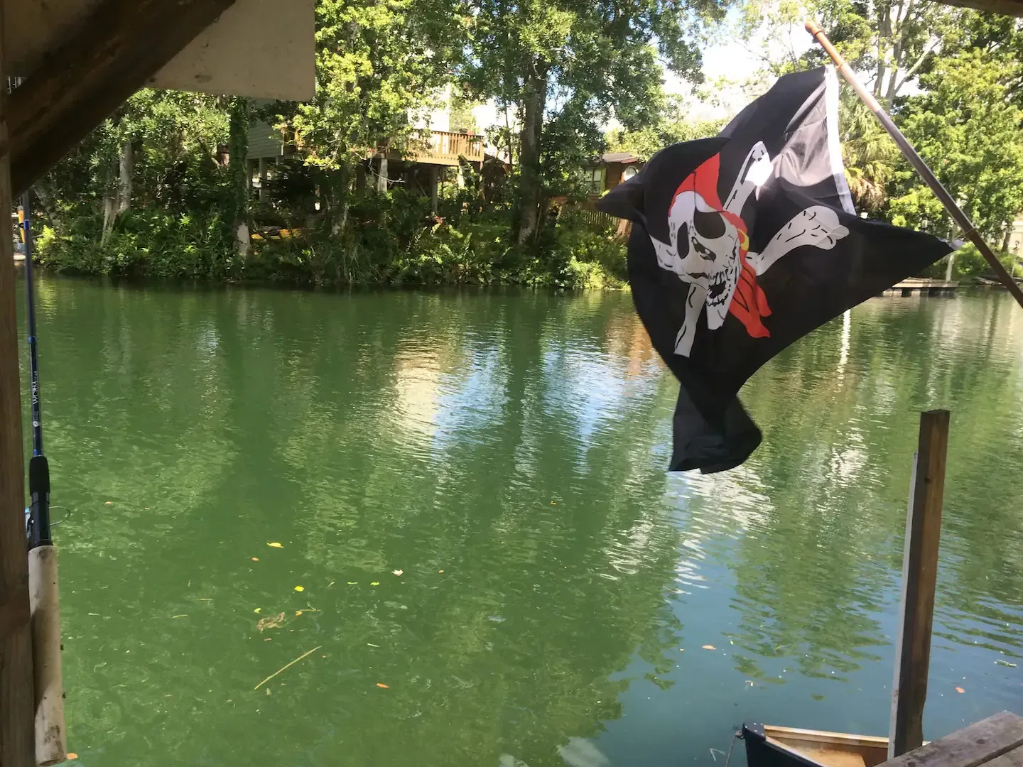 A pirate flag is flying over a body of water
