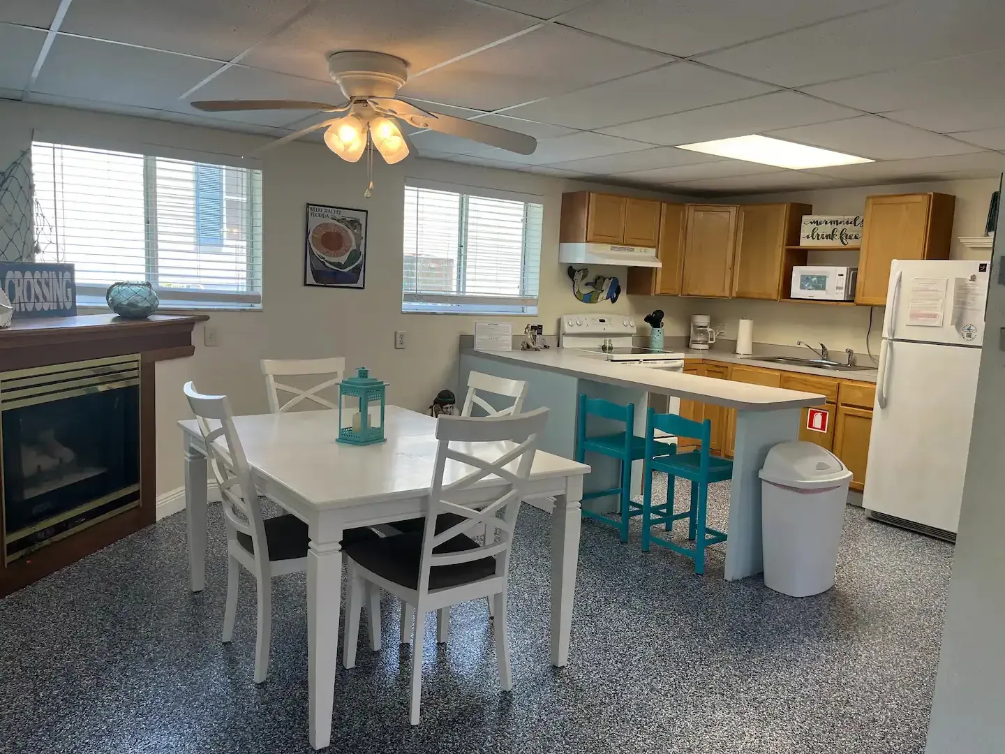 A kitchen with a table and chairs and a fireplace.