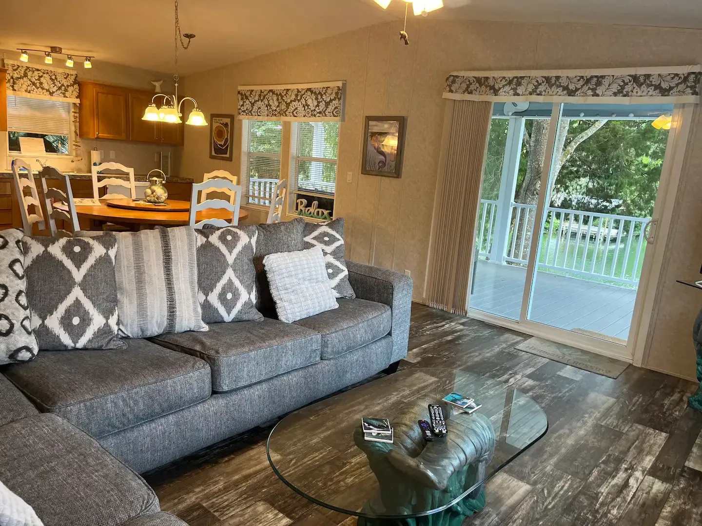 A living room with a couch , coffee table , and sliding glass doors leading to a balcony.