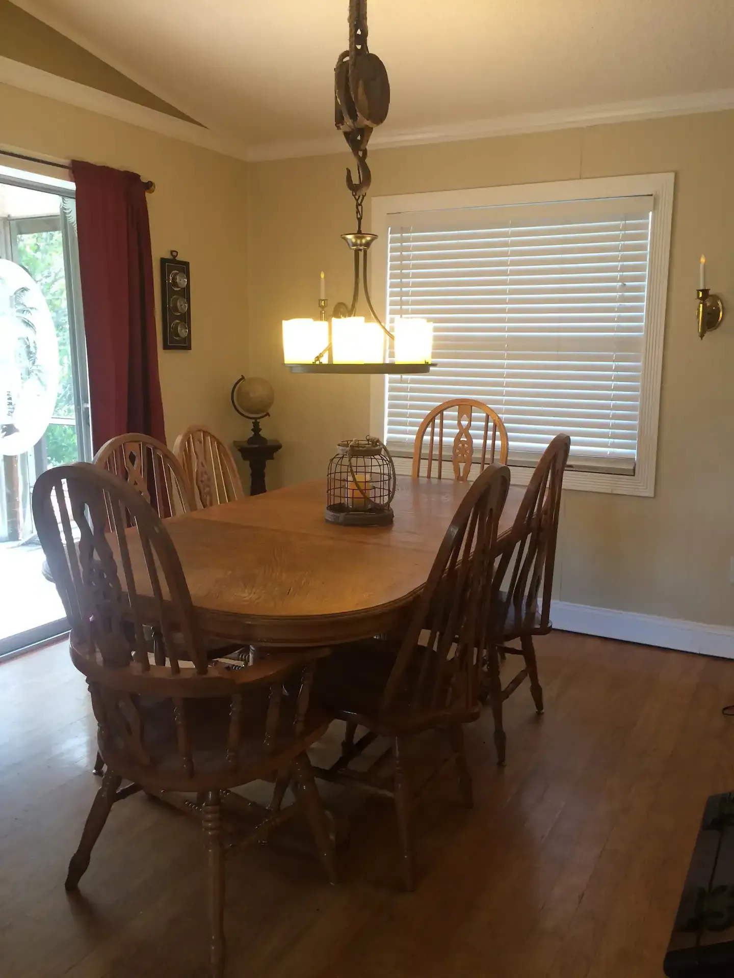 A dining room with a table and chairs and a window