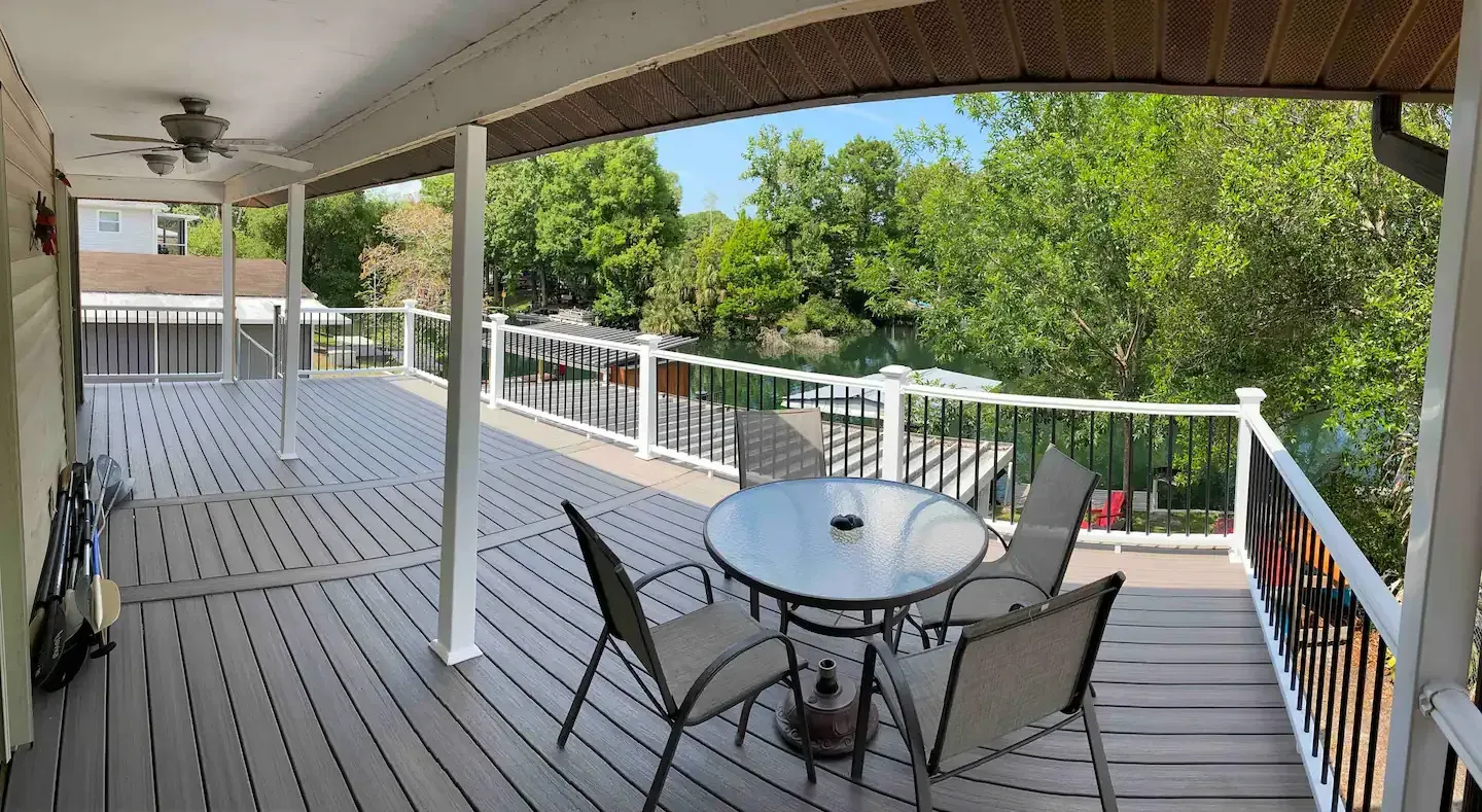 A large deck with a table and chairs on it