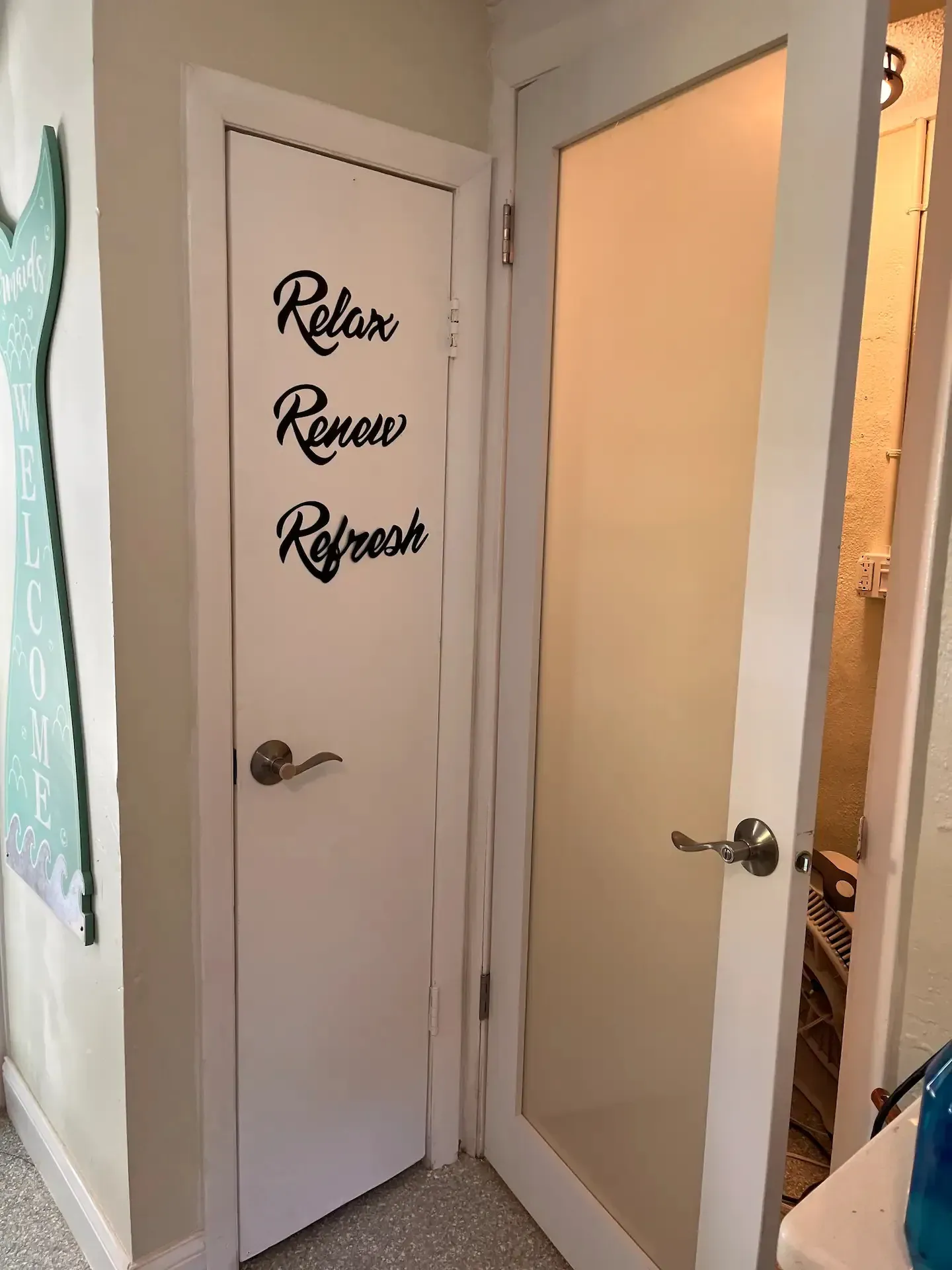 A door with a sign on it that says `` relax , renew , refresh ''.