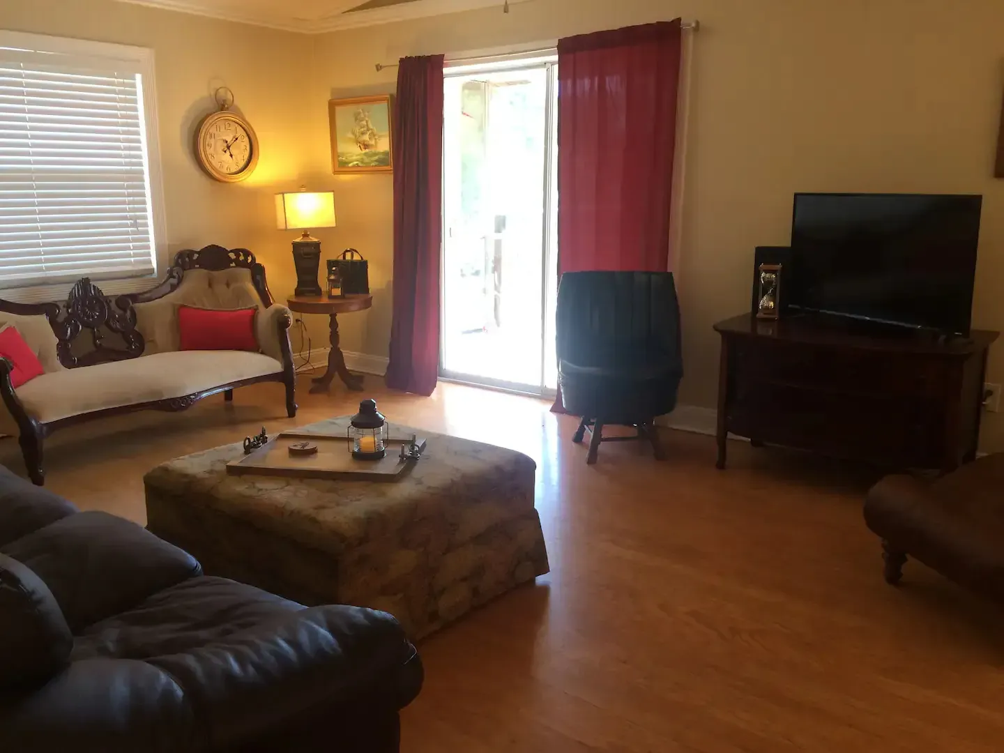 A living room with a couch ottoman and television