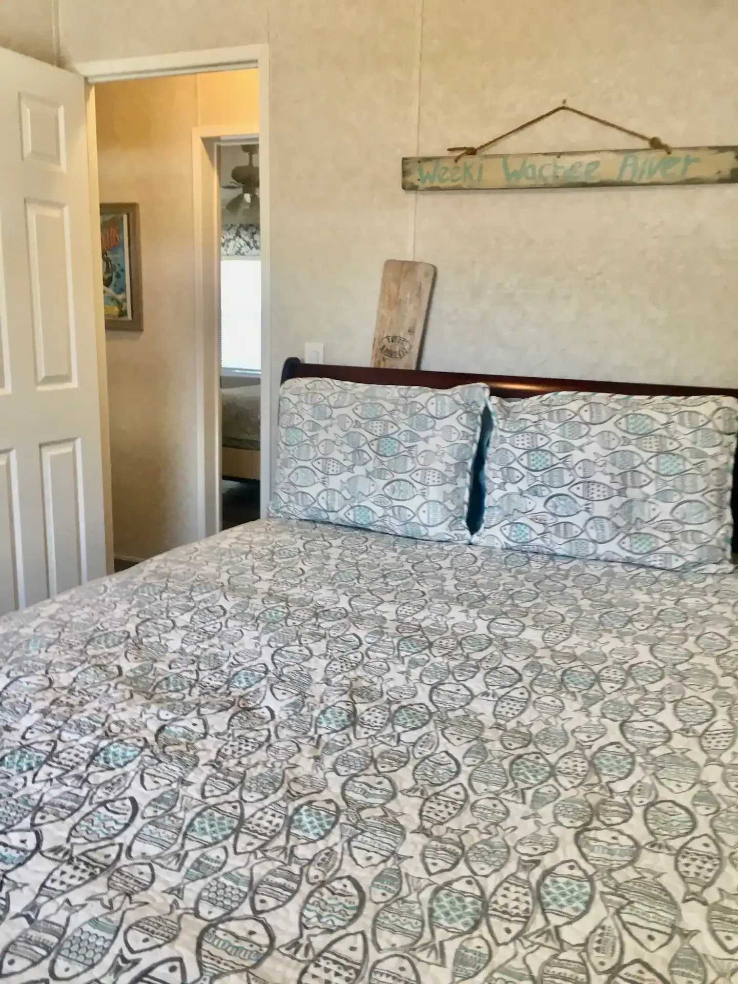 A bedroom with a bed and a door leading to a bathroom.