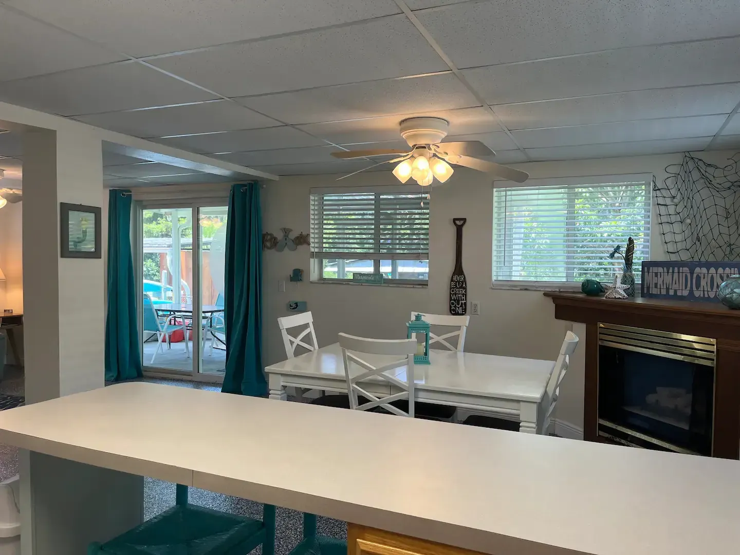 A dining room with a table and chairs and a fireplace.