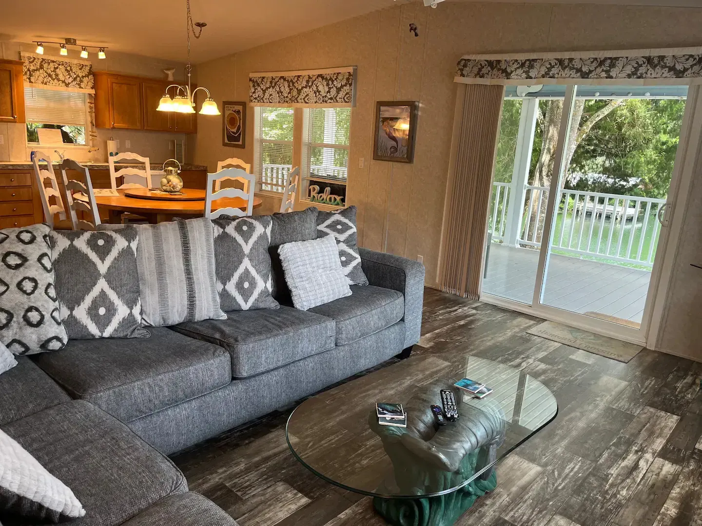 A living room with a couch , coffee table and sliding glass doors leading to a balcony.