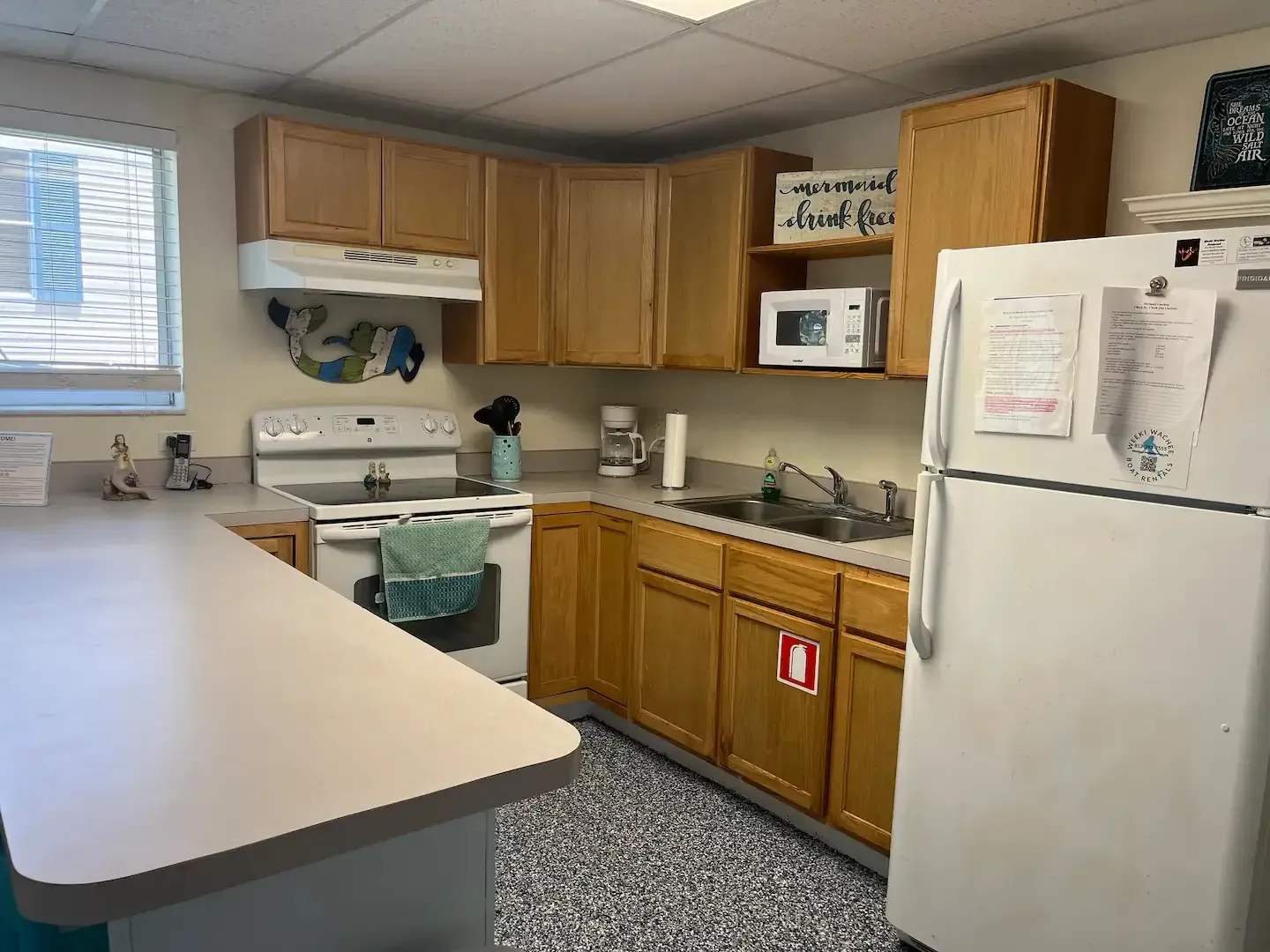 A kitchen with wooden cabinets and a white refrigerator