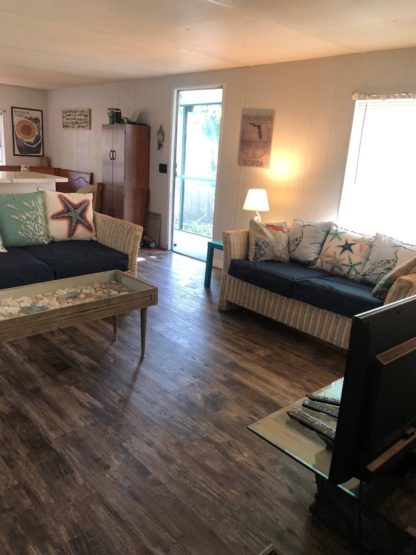 A living room with a couch , table , and television.