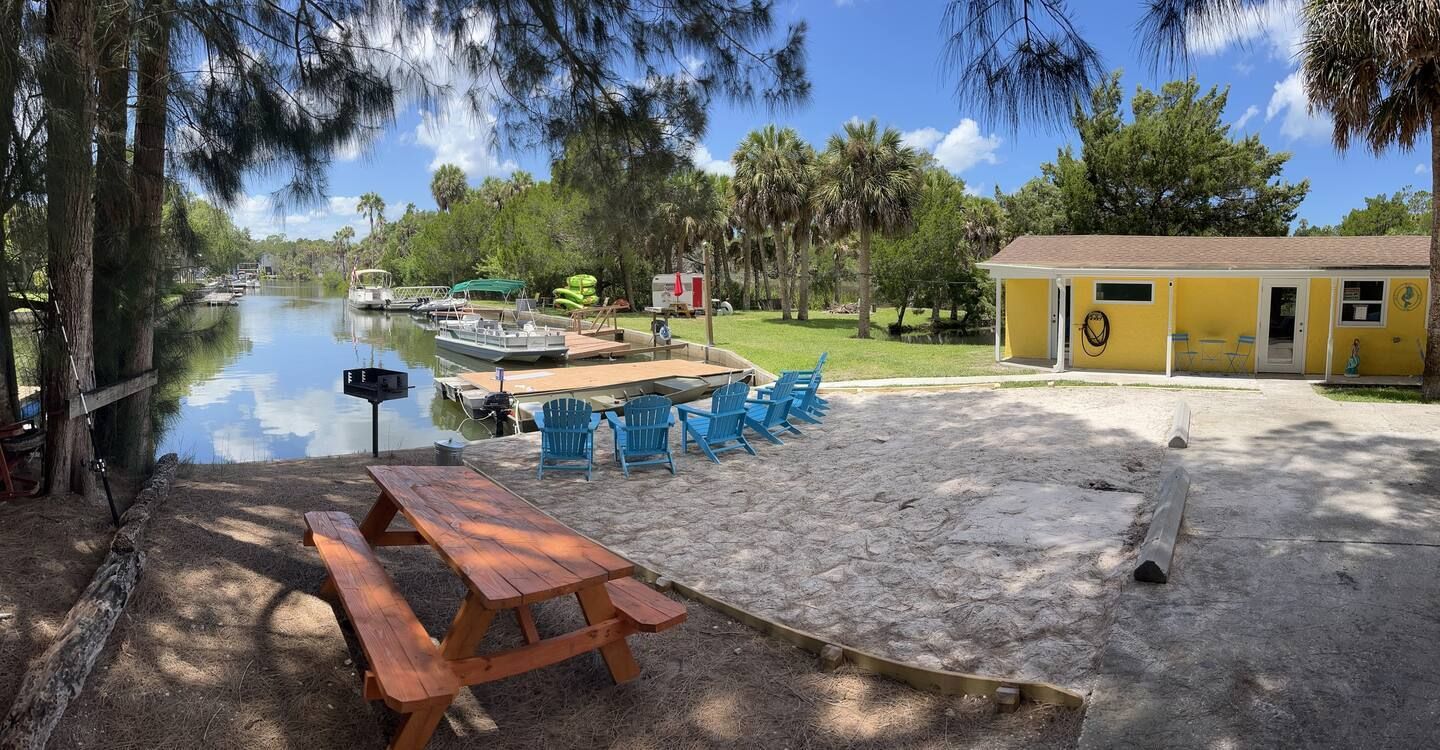 A picnic table is sitting next to a body of water.