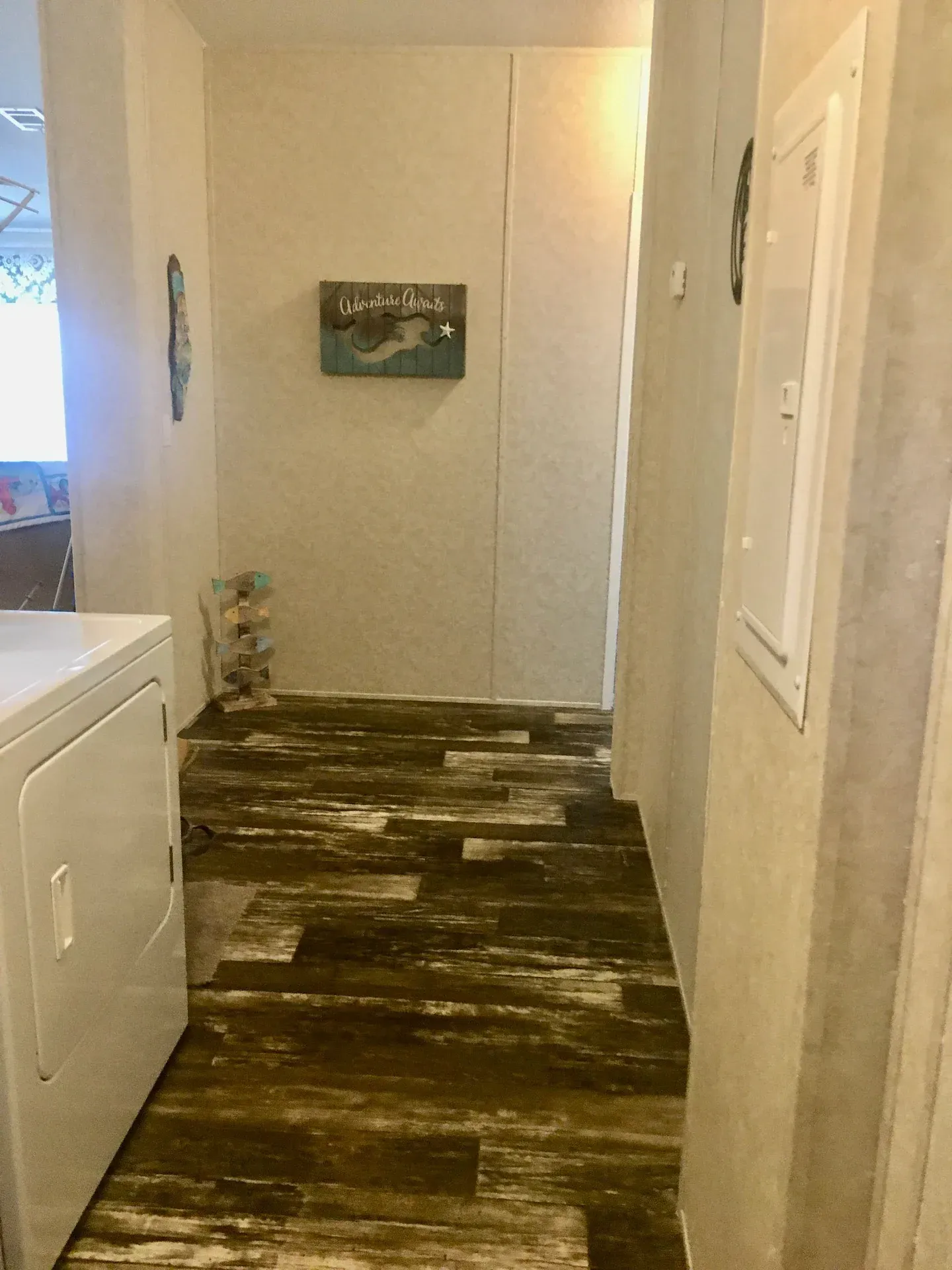A hallway with a washer and dryer in it.