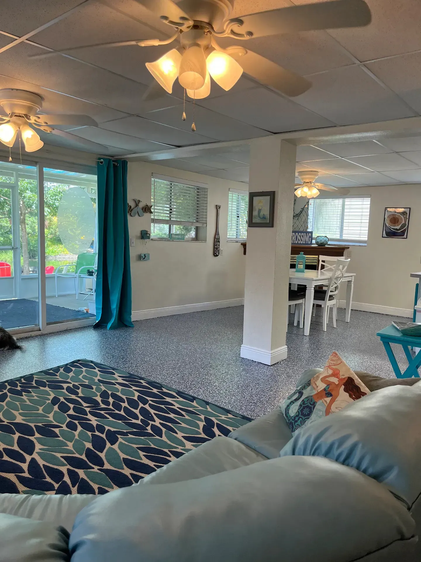 A living room with a ceiling fan and a couch.