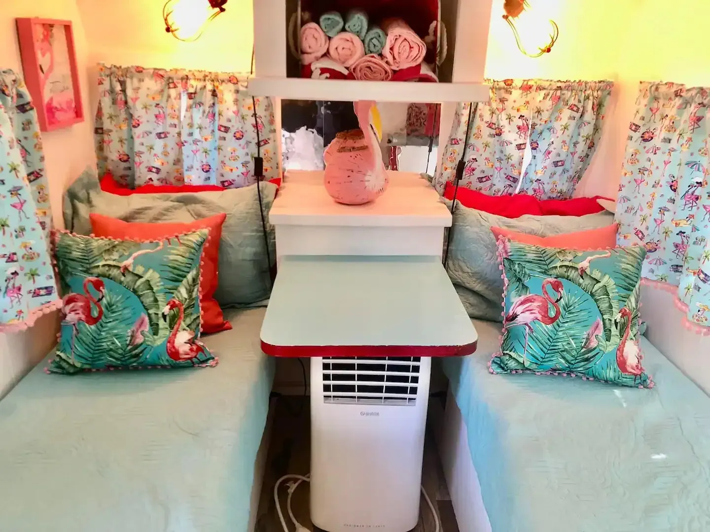 The inside of a camper with two beds and a table