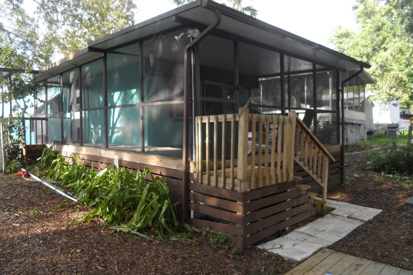 A house with a screened in porch and stairs