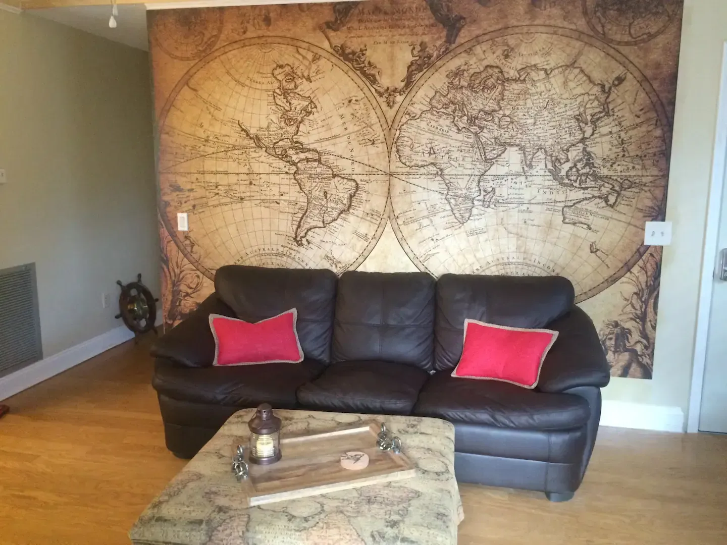 A living room with a couch and a map on the wall