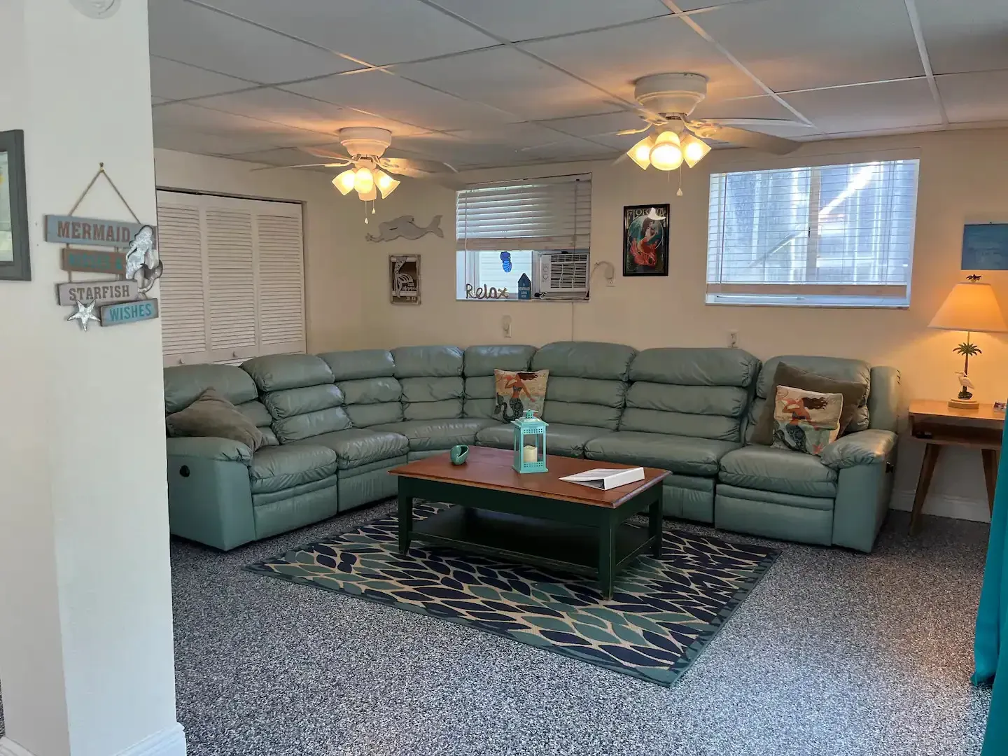 A living room with a large sectional couch and a coffee table.