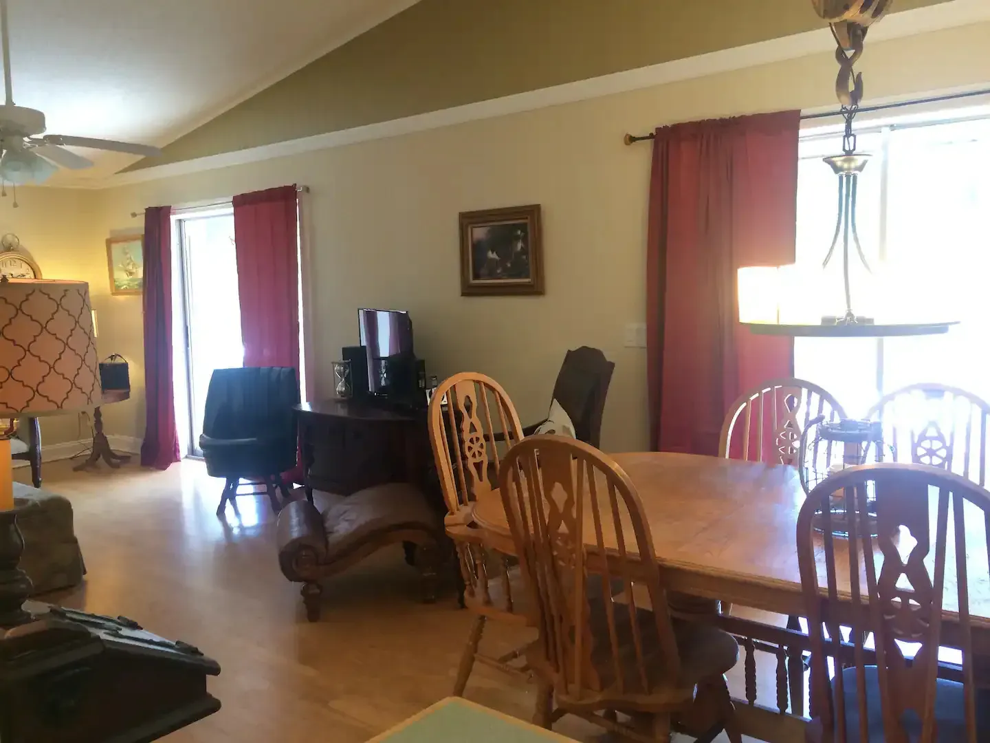 A living room with a wooden table and chairs