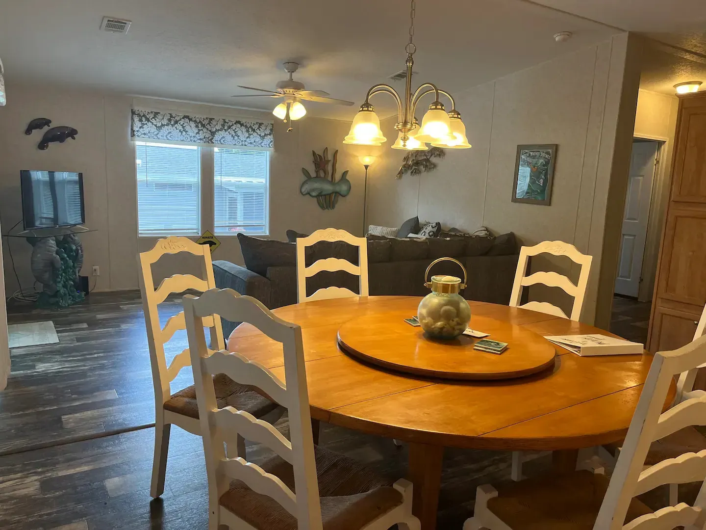 A dining room with a round table and chairs in a mobile home.