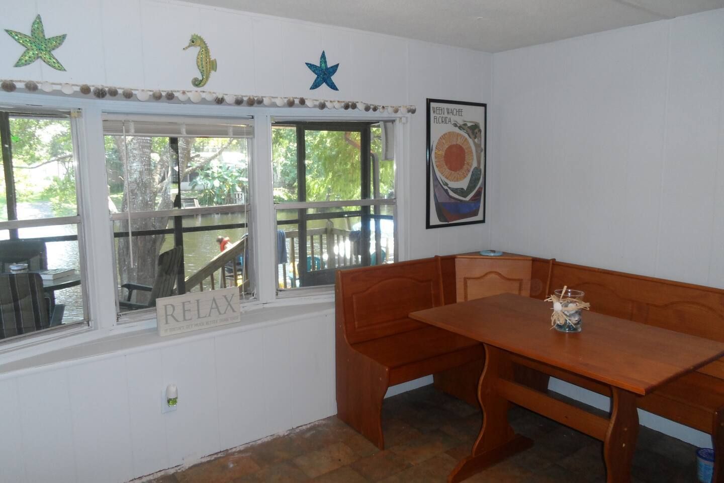 A room with a table and bench and a sign that says relax