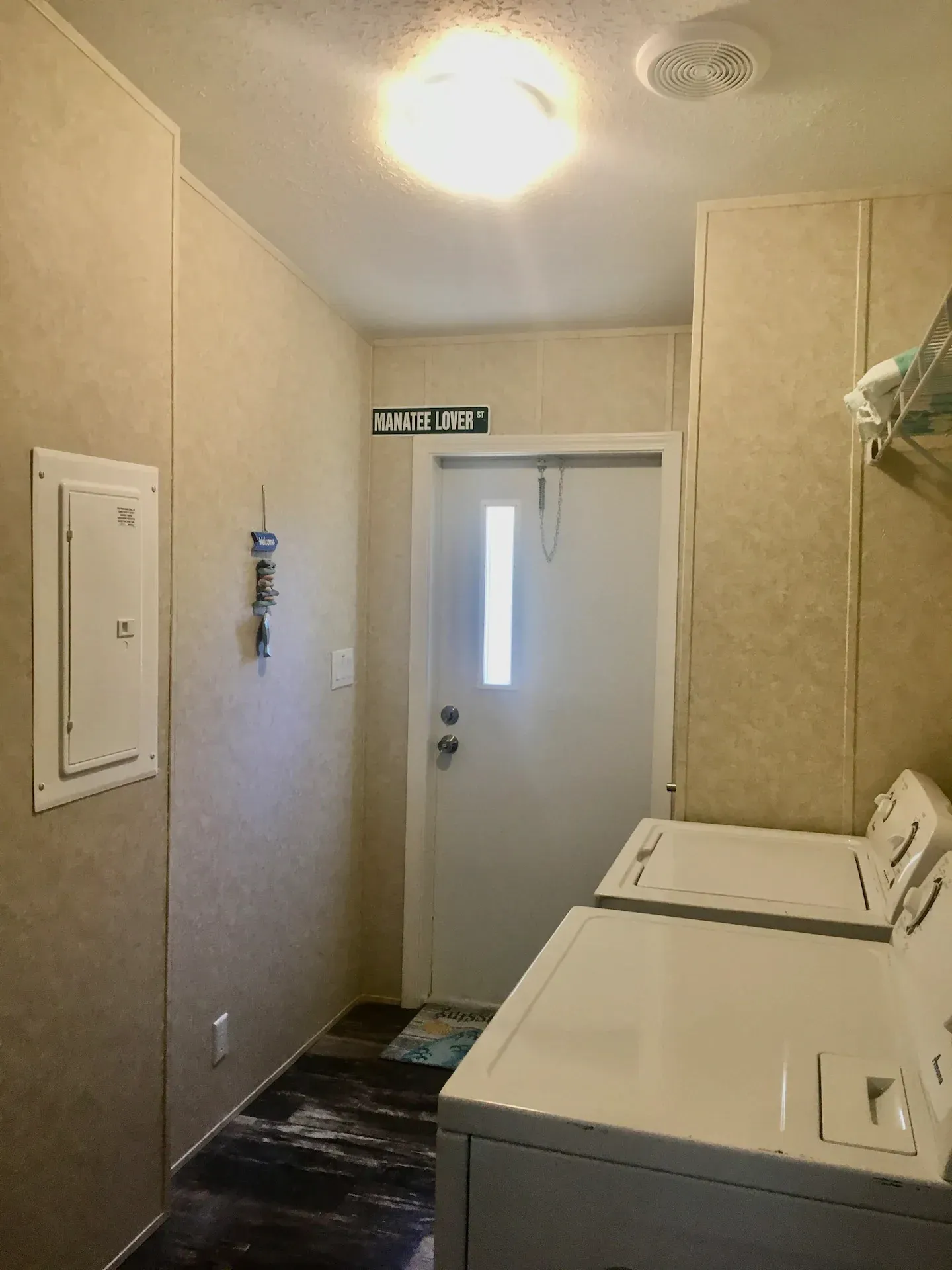 A laundry room with a washer and dryer and a door.