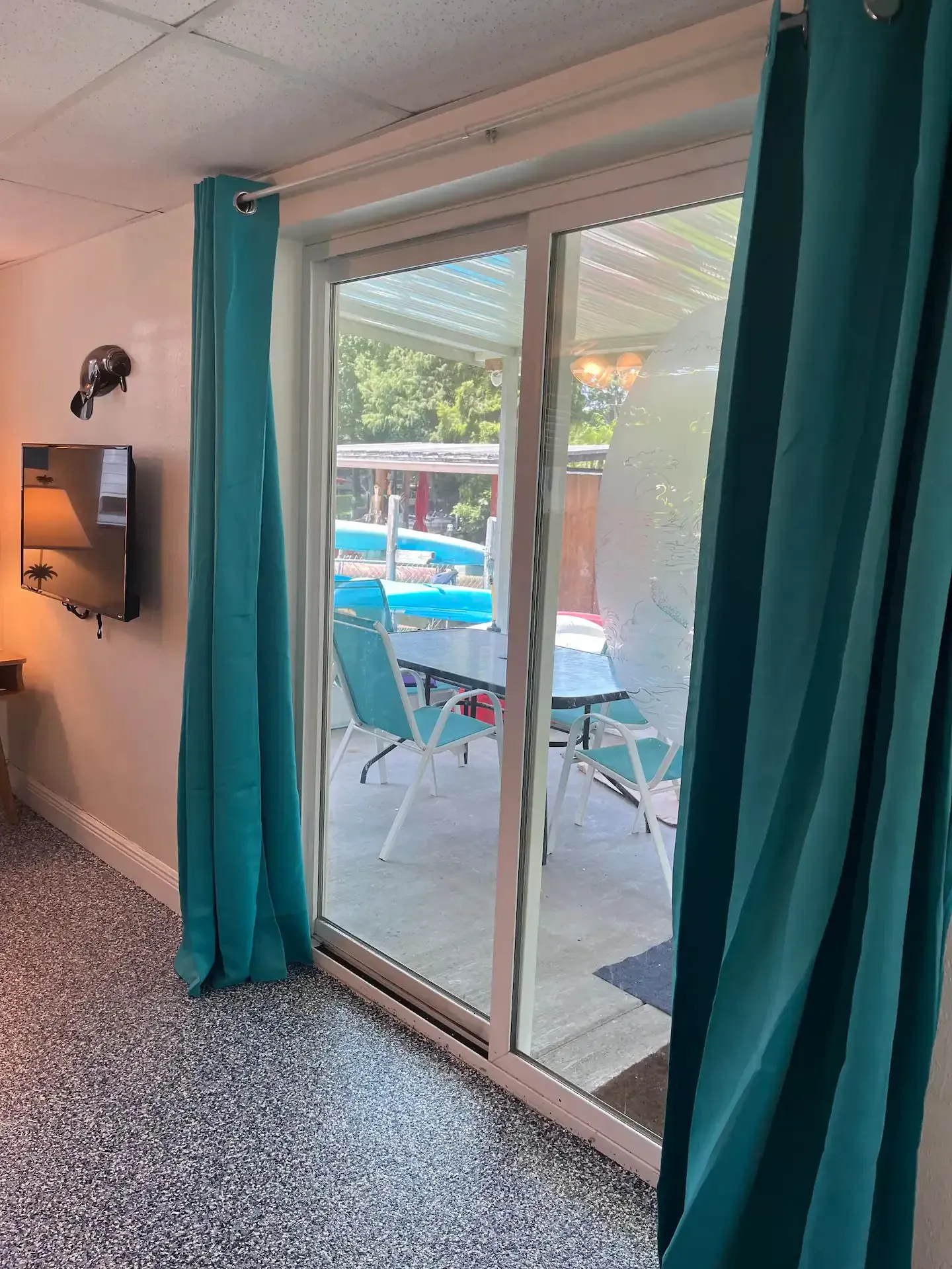 A living room with a sliding glass door leading to a patio.
