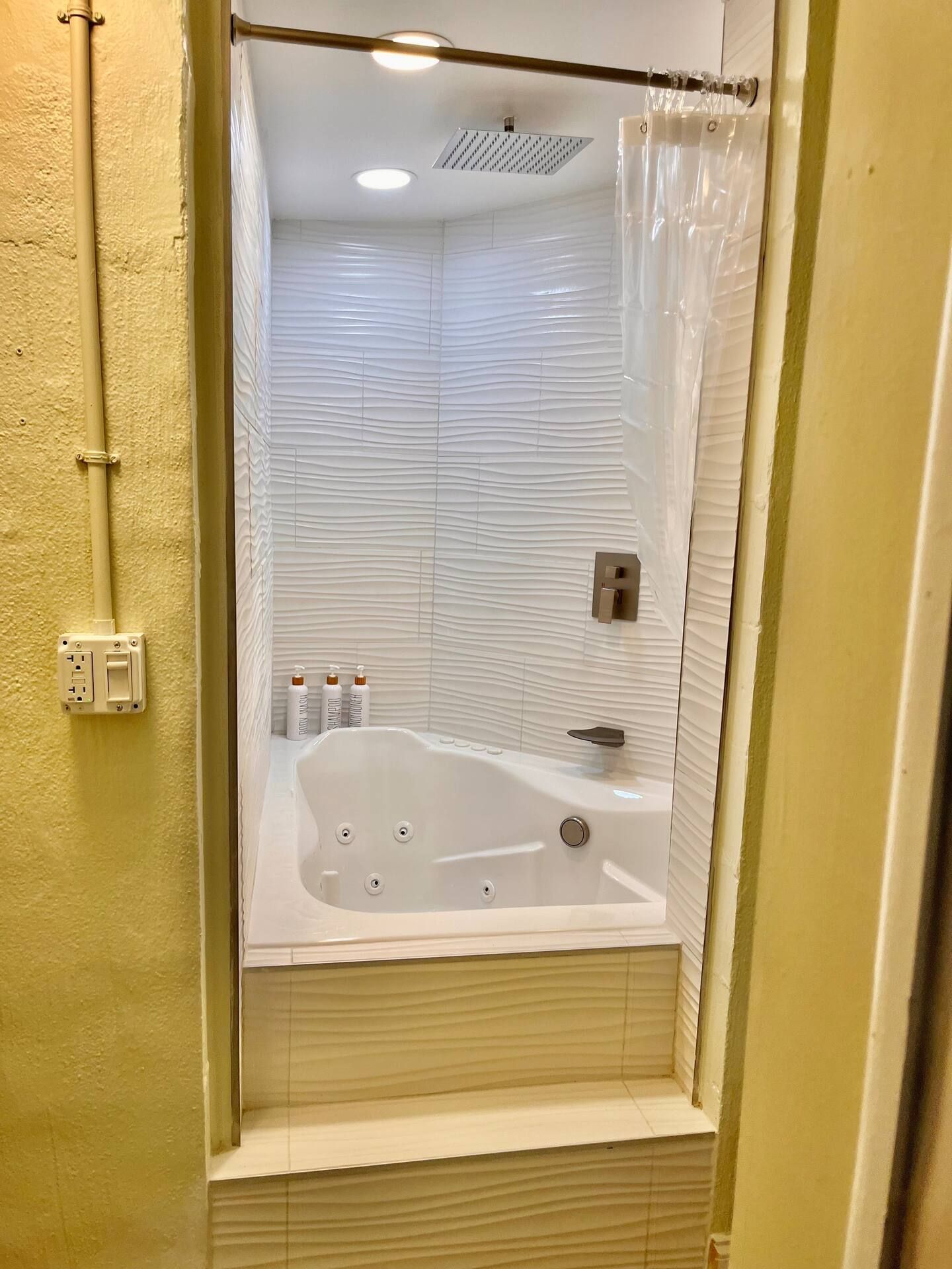 A bathroom with a jacuzzi tub and a shower.