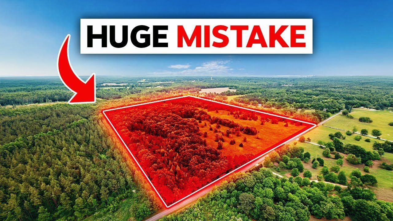 Aerial view of a large plot of land marked in red, with a forest and the text