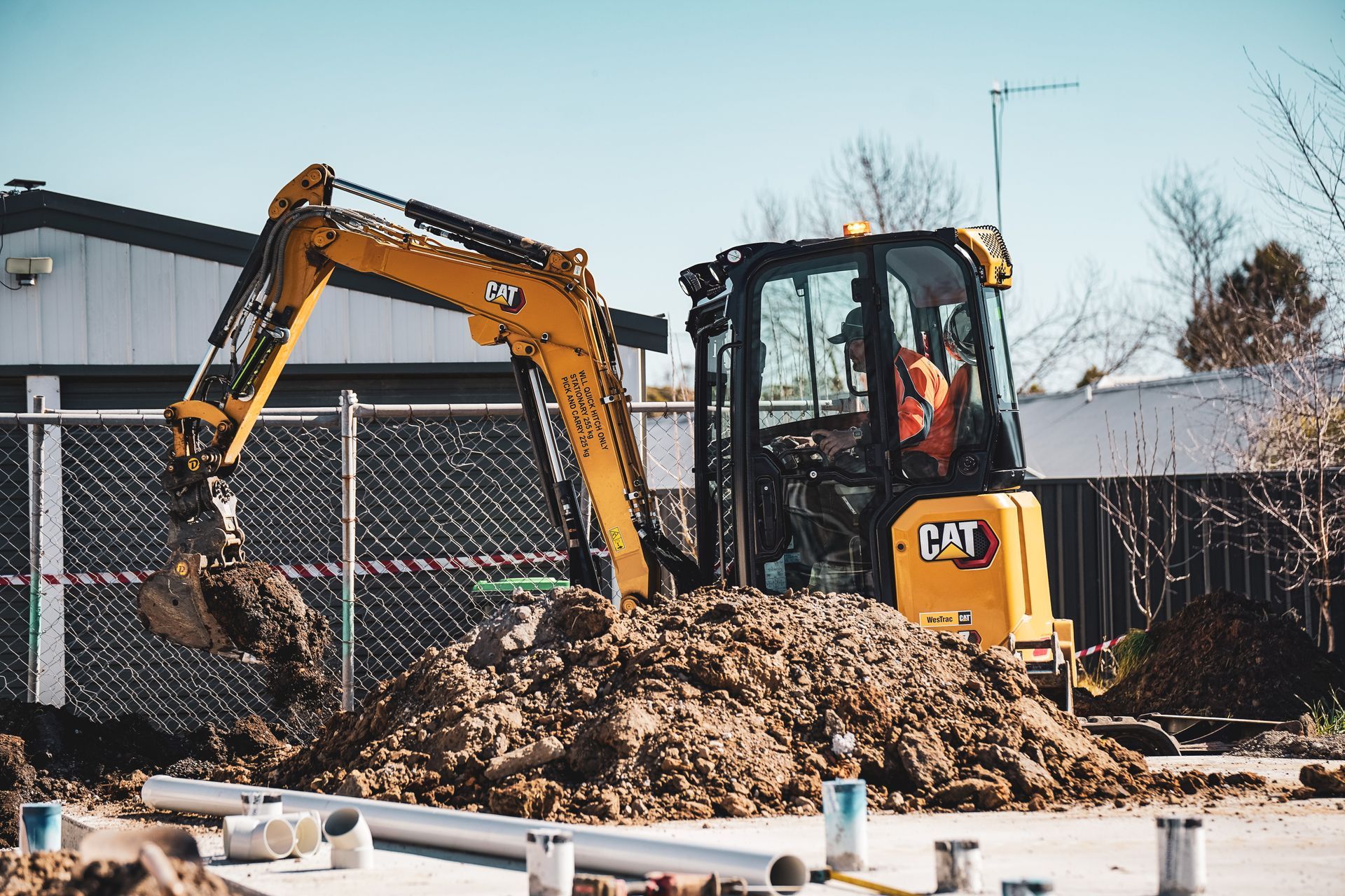 A Yellow Excavator Is Digging A Hole In The Ground — Hydro Excavation in Goulburn, NSW