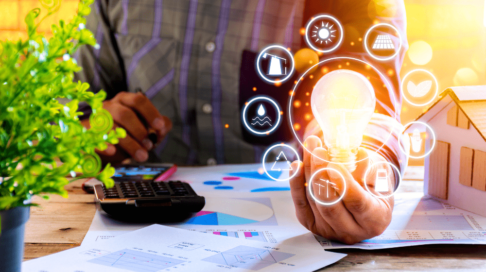 Person using a laptop at a desk with charts, calculator, and glowing digital technology icons
