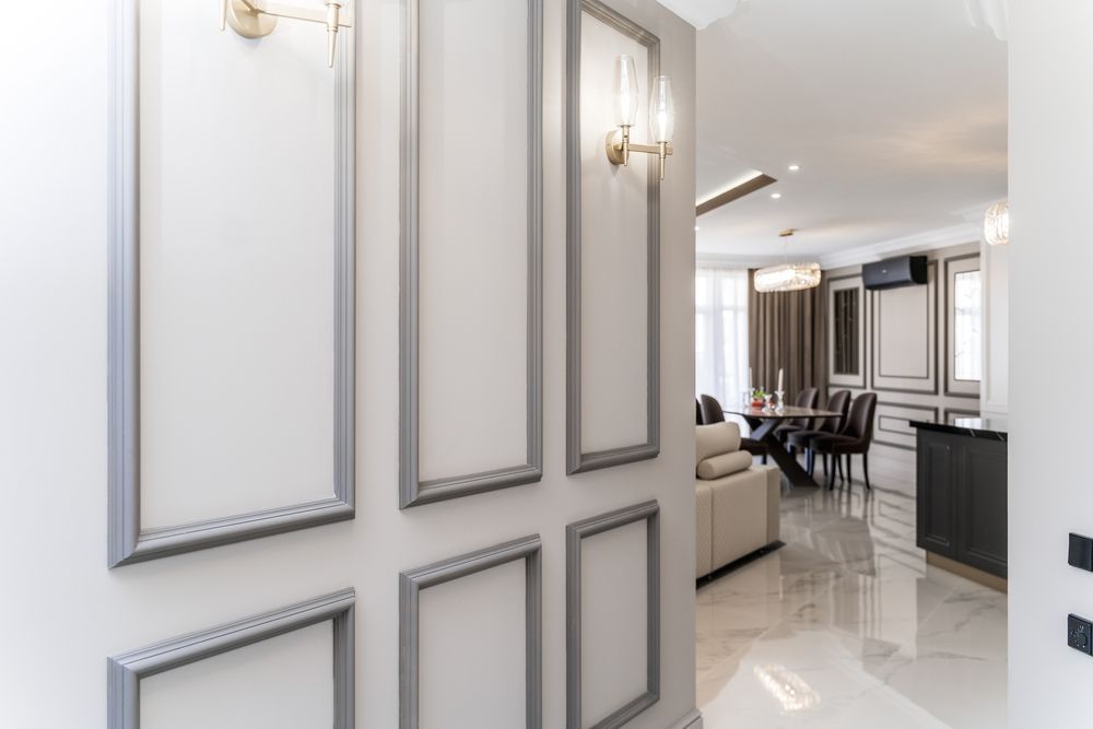 A hallway with a door leading to a living room and dining room.