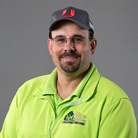 Man with glasses, wearing a gray cap with 