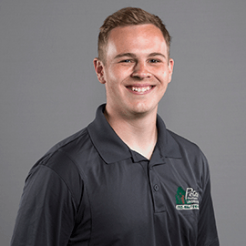 Man with fair skin and a polo shirt smiling, headshot.