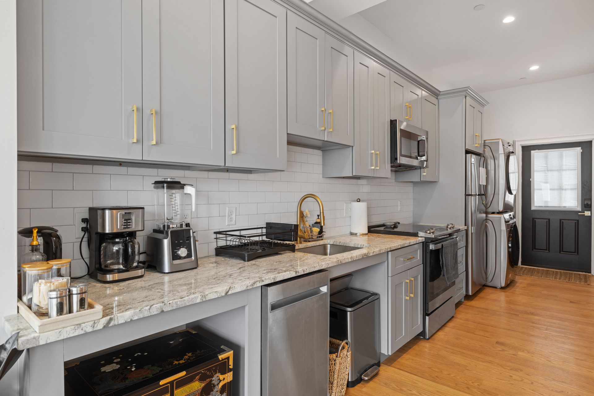 A kitchen with stainless steel appliances and granite counter tops.