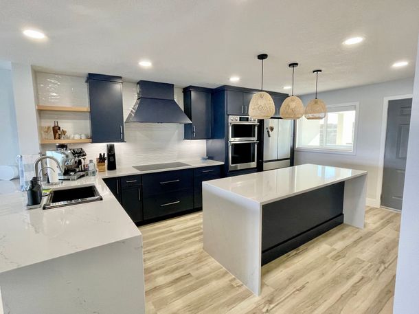 A kitchen with a large island in the middle of it