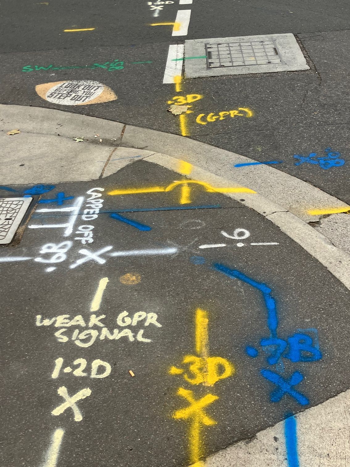 A Group Of Construction Workers Are Working On A Drain In A Parking Lot — East Coast Locating Services In Wallalong, NSW