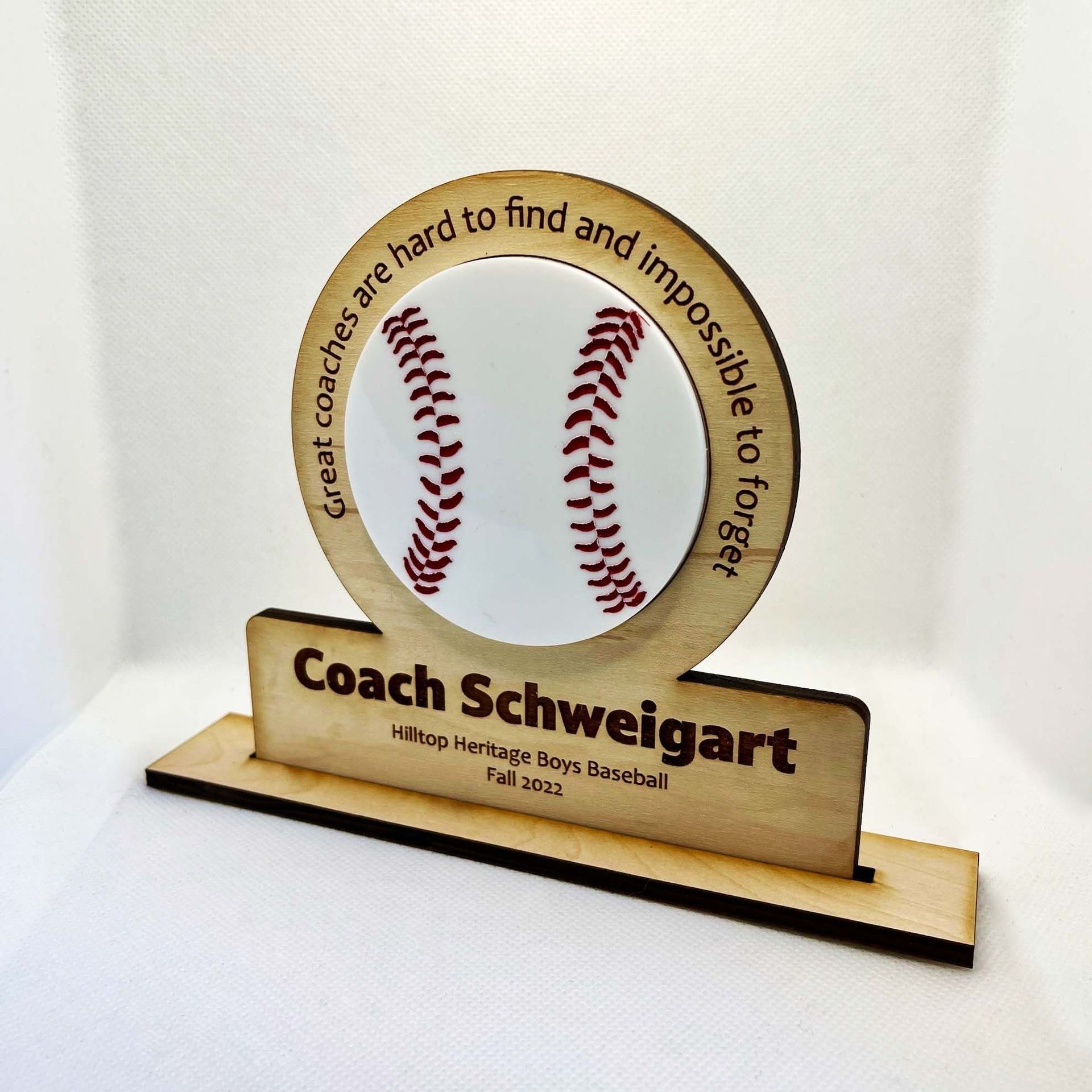 A wooden plaque that says coach schwalgart on it