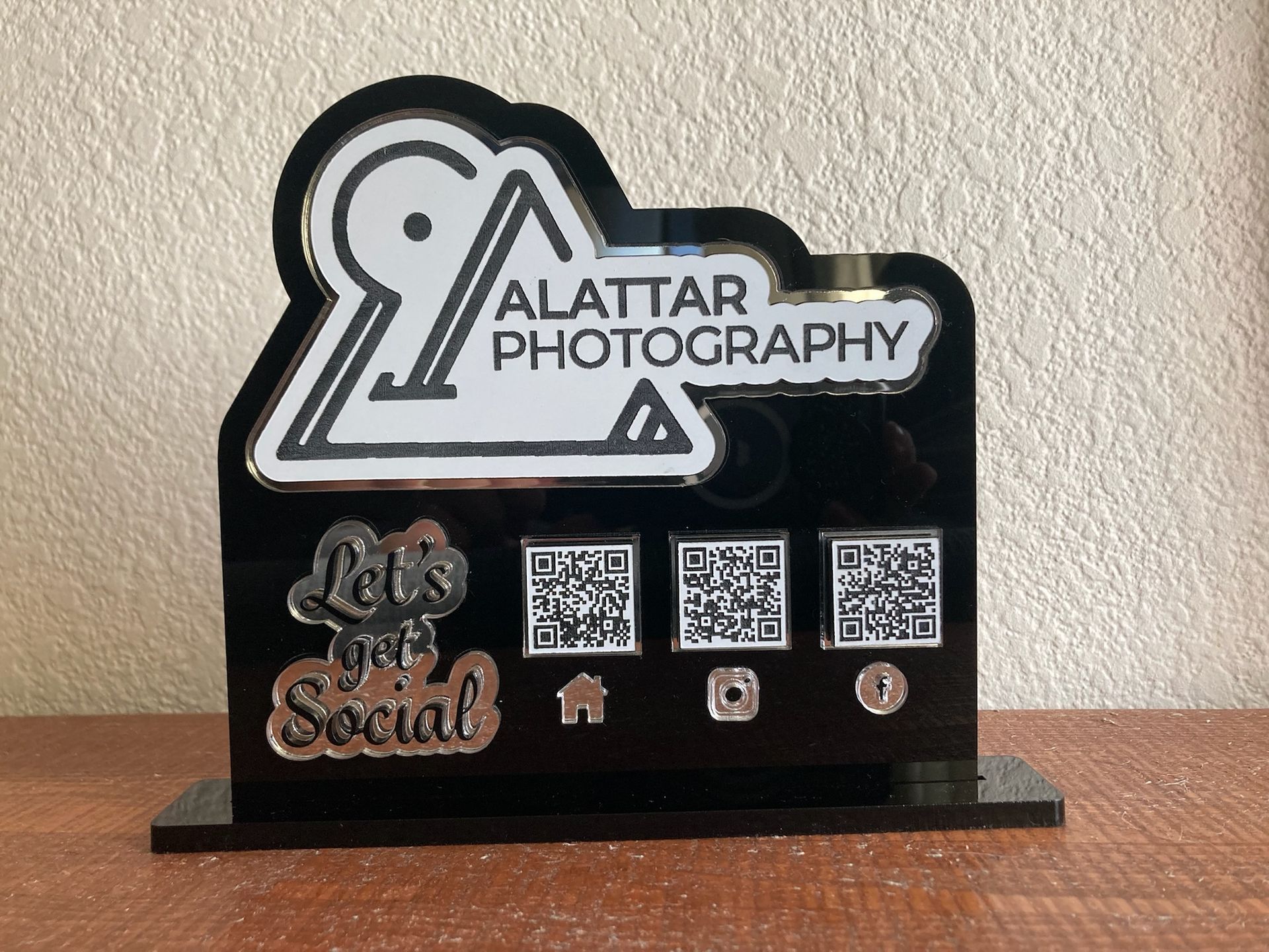 A sign for alattar photography says let 's get social