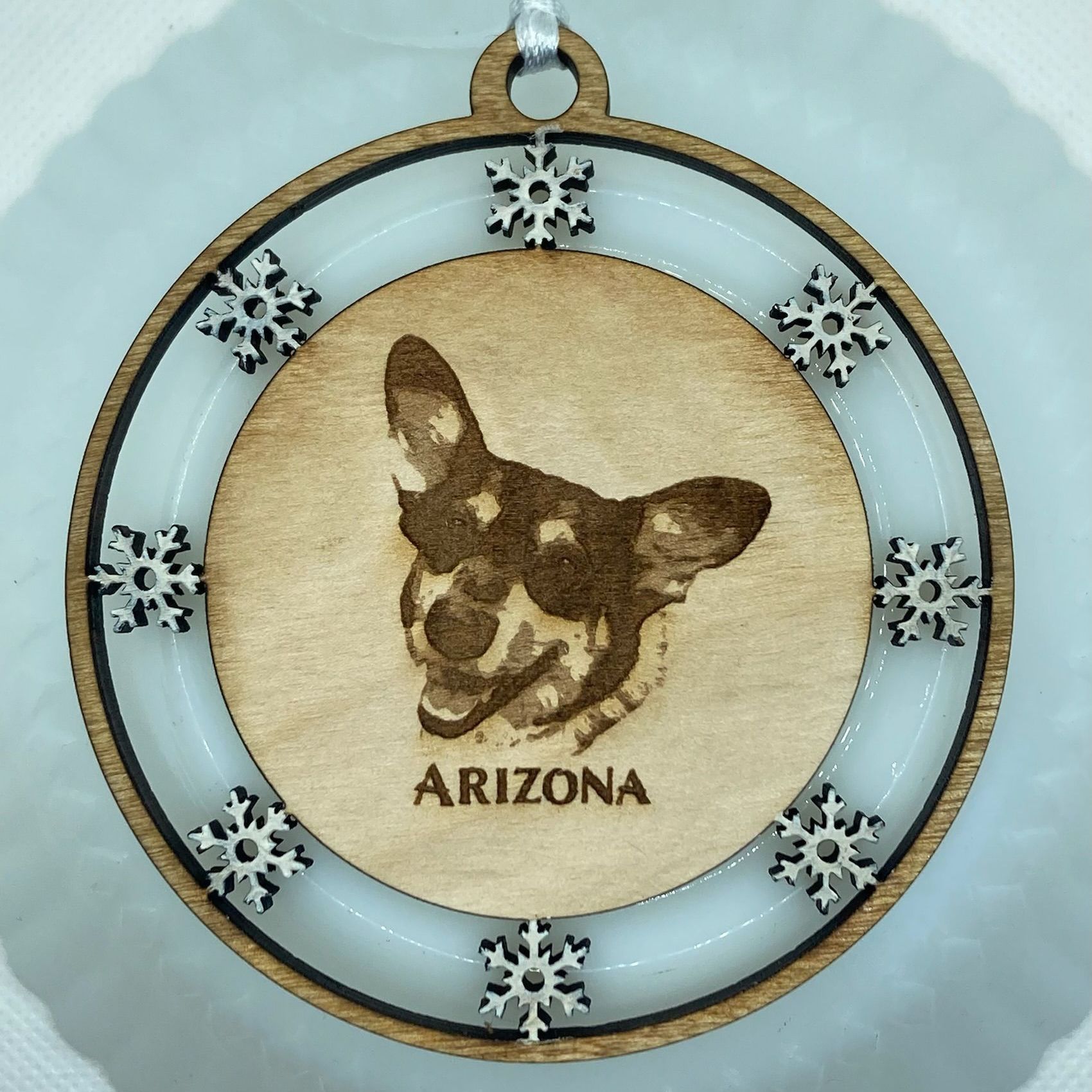 An arizona ornament with a picture of a dog on it