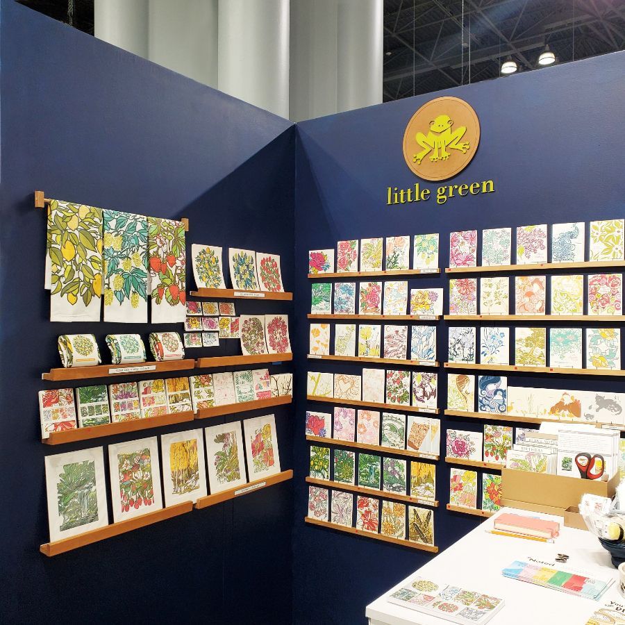 A store called little green has lots of cards on shelves